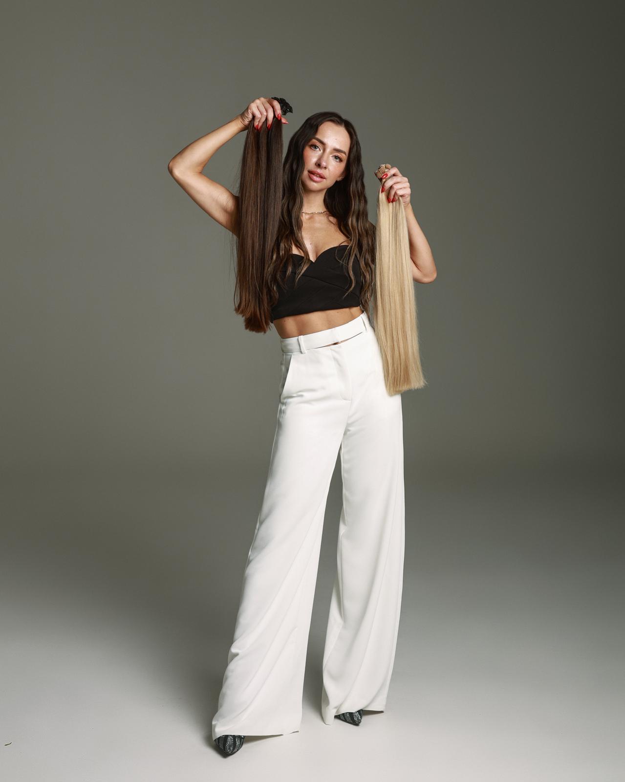 Iryna holding brunette and blonde single-donor hair extensions